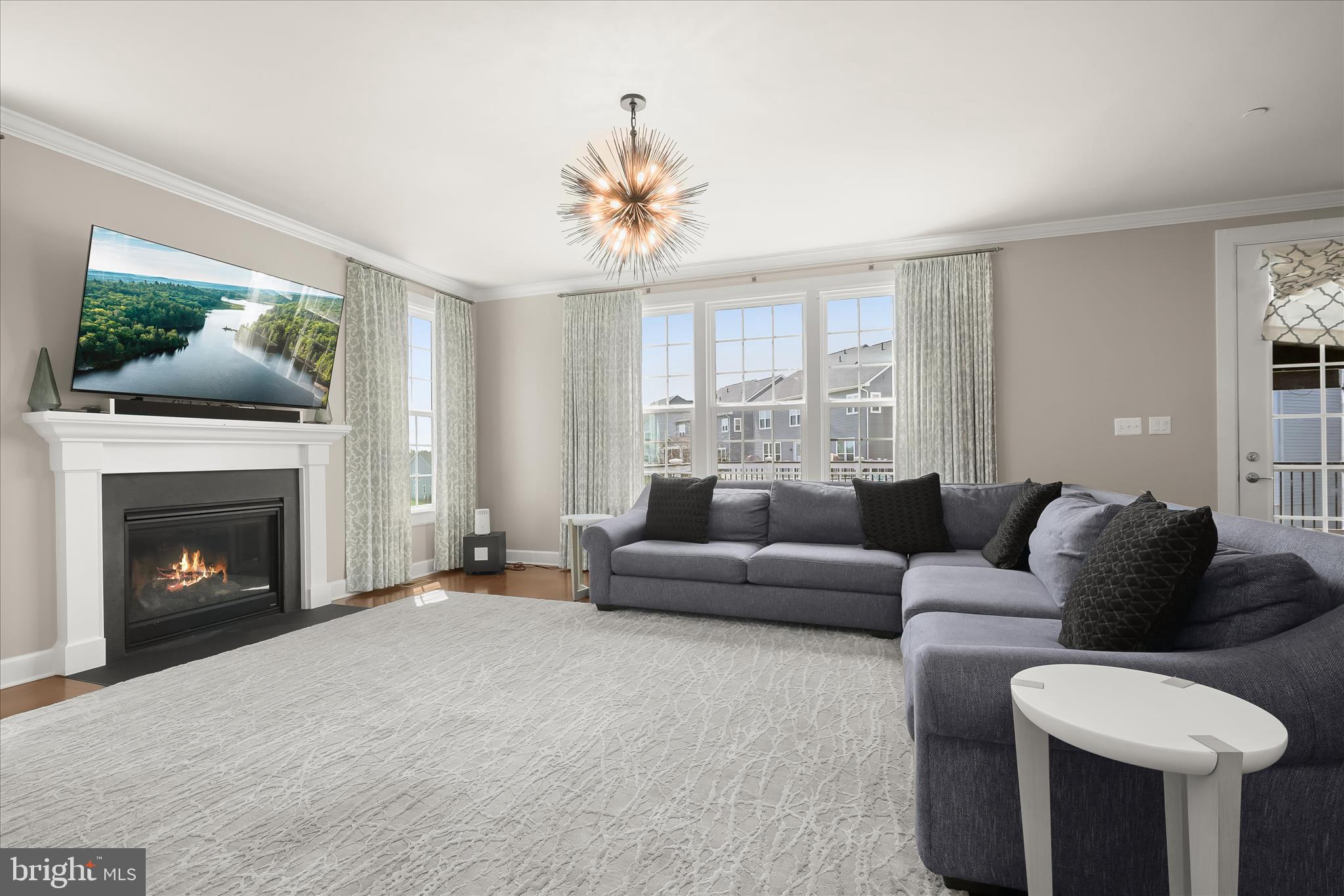 11047 Martha Way Fulton, MD 20759 - Photo 25 of 87 a living room with furniture a fireplace and a flat screen tv