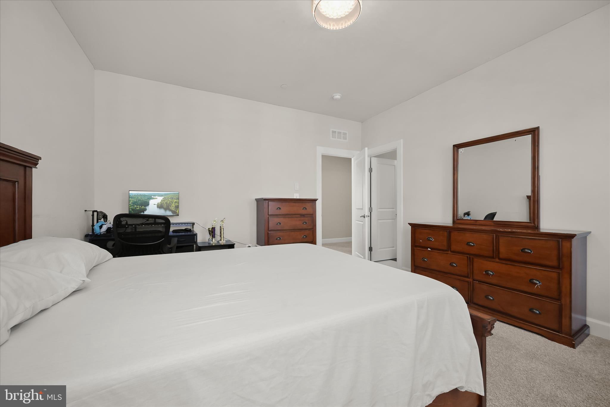 11047 Martha Way Fulton, MD 20759 - Photo 43 of 87 a bedroom with a bed and a large mirror on dresser