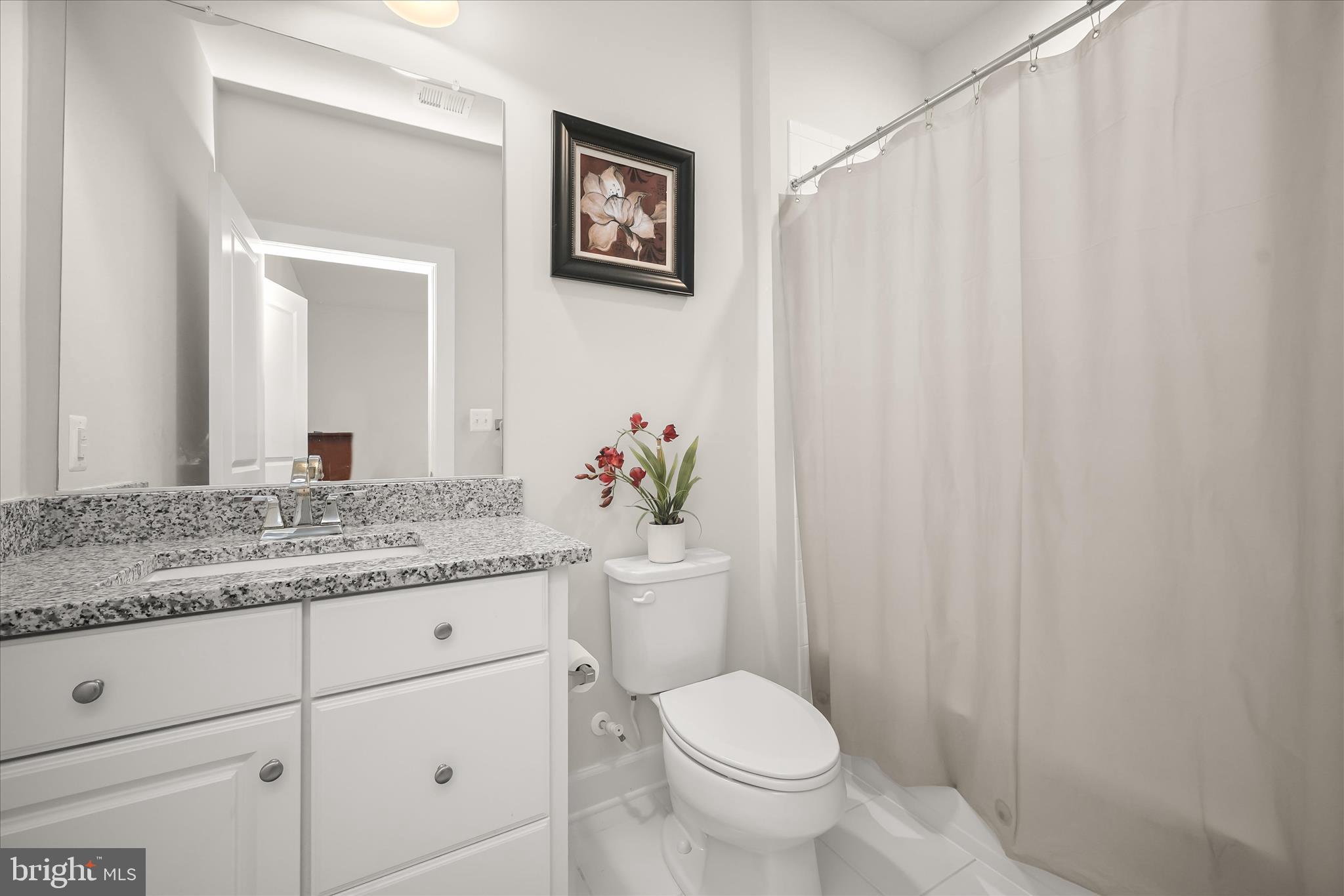 11047 Martha Way Fulton, MD 20759 - Photo 44 of 87 a bathroom with a granite countertop sink toilet and a mirror