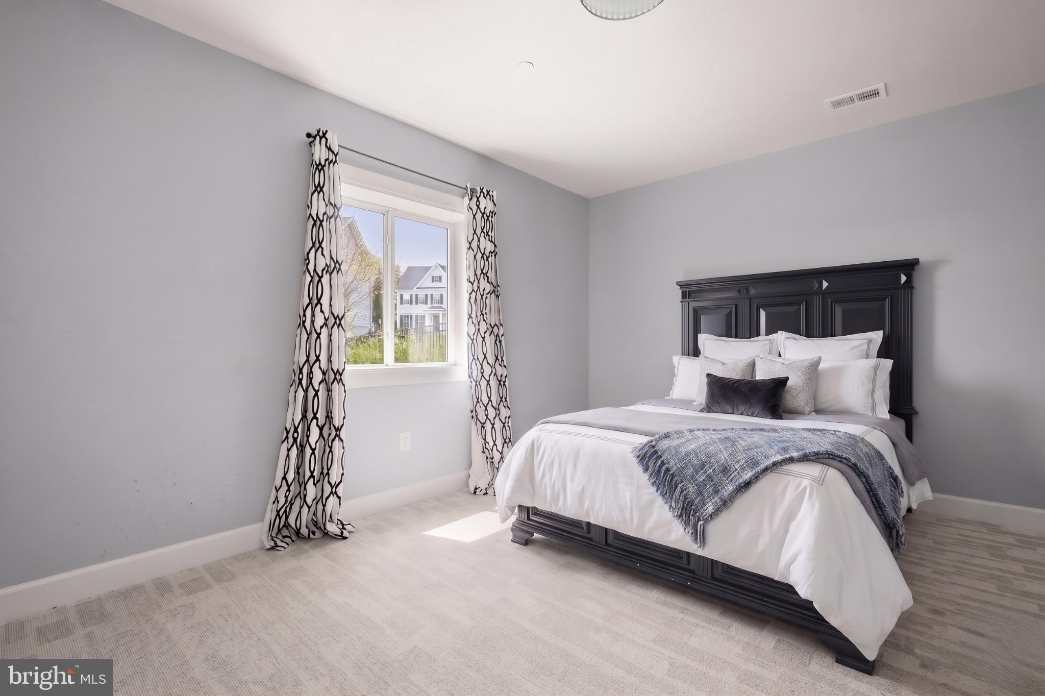 11047 Martha Way Fulton, MD 20759 - Photo 48 of 80 a spacious bedroom with a bed and a window