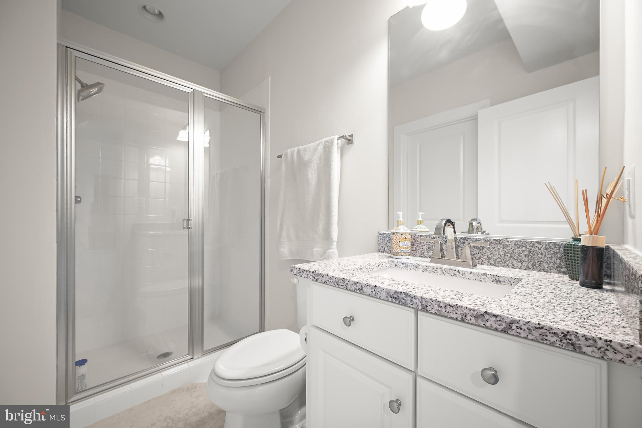 11047 Martha Way Fulton, MD 20759 - Photo 49 of 80 a bathroom with a granite countertop sink toilet and shower