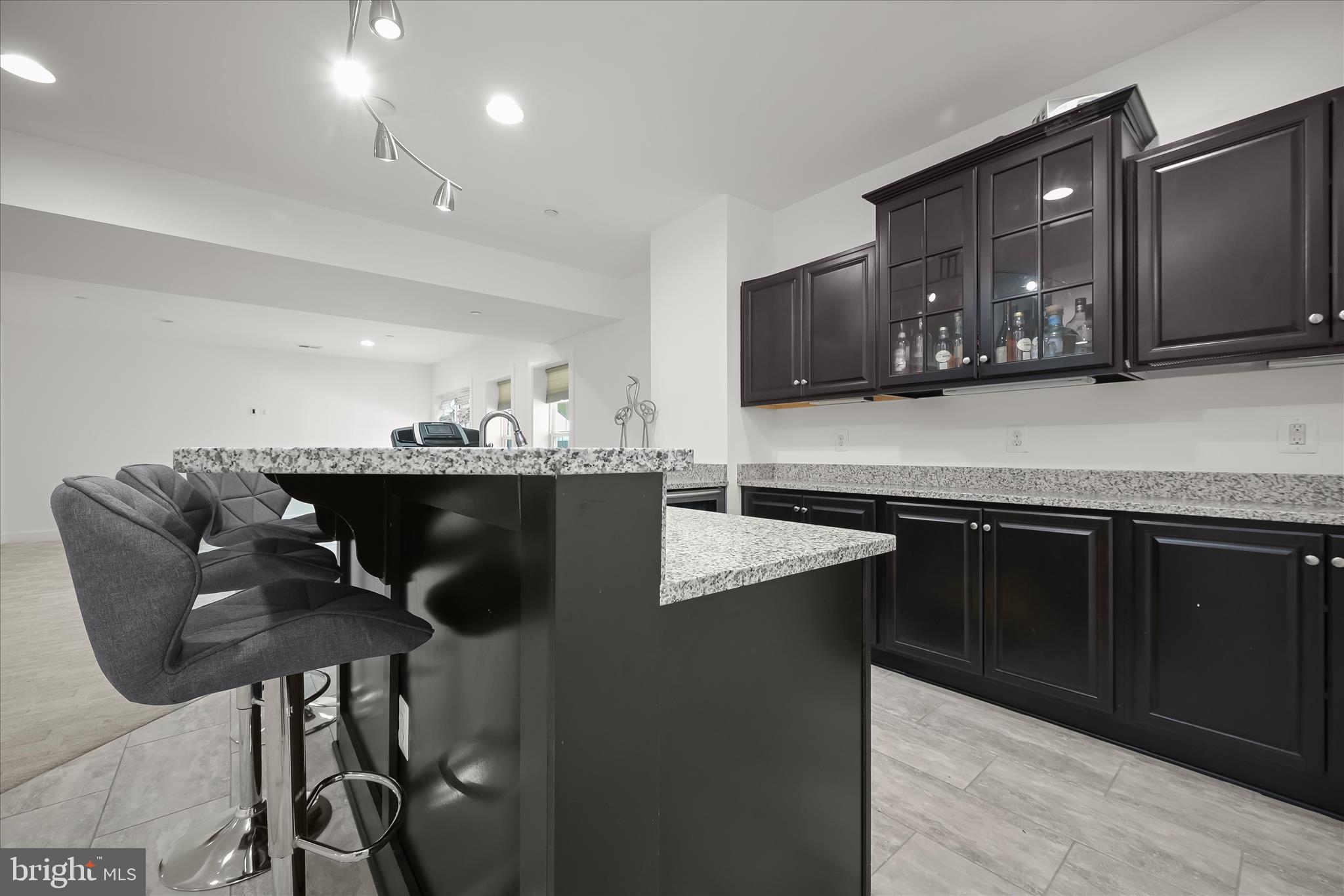 11047 Martha Way Fulton, MD 20759 - Photo 49 of 87 a kitchen with kitchen island granite countertop a sink cabinets and wooden floor