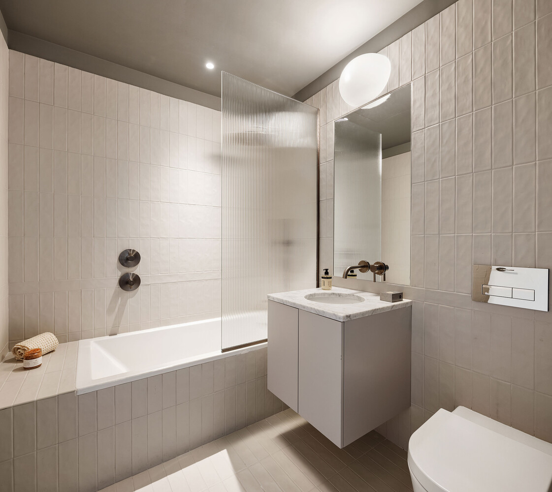 144 Vanderbilt Avenue, Unit 4A Brooklyn, NY 11205 - Photo 11 of 24 a bathroom with a sink a toilet and shower