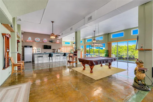 a living room with patio furniture and a large window