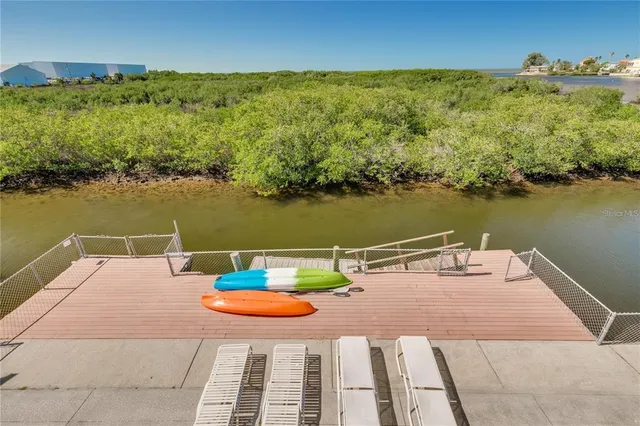 an outdoor space with furniture and a lake view