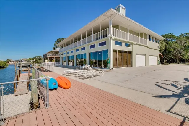 an aerial view of a house with a yard and lake view