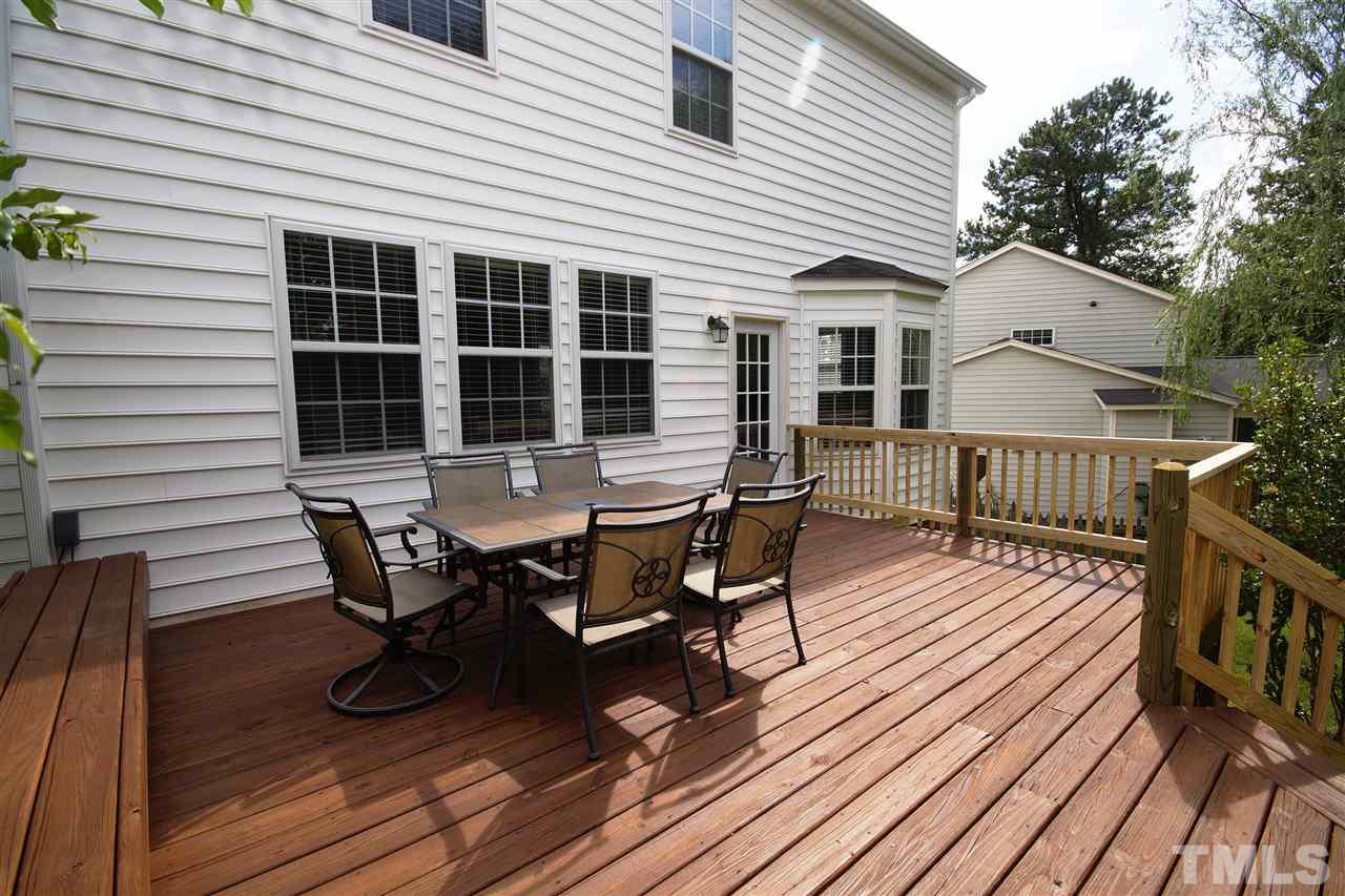 8512 Metronome Lane Raleigh, NC 27613 - Photo 3 of 4 a roof deck with table and chairs and wooden floor