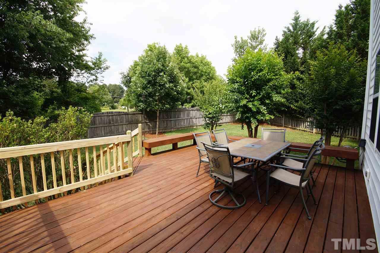 8512 Metronome Lane Raleigh, NC 27613 - Photo 4 of 4 a view of a roof deck with table and chairs and wooden floor