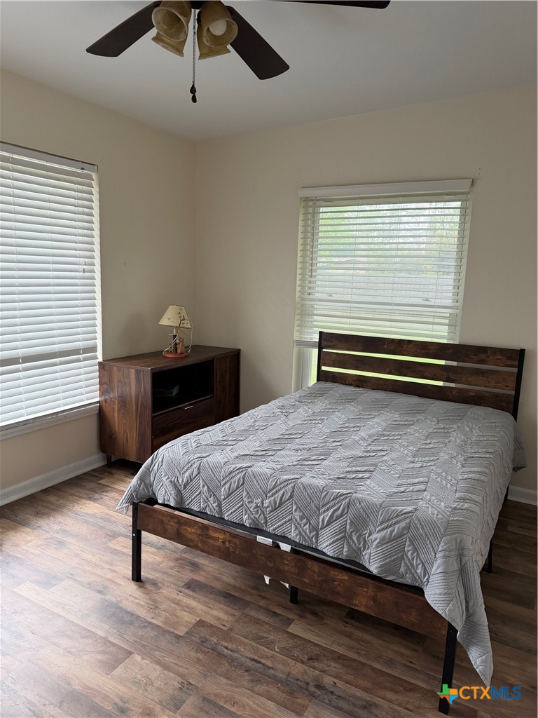 202 Bonham Street Port Lavaca, TX 77979 - Photo 9 of 11 a bedroom with a bed and a chandelier