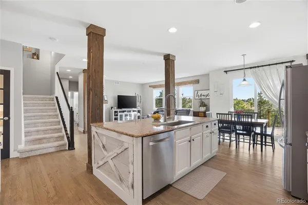 a dining room with furniture and wooden floor