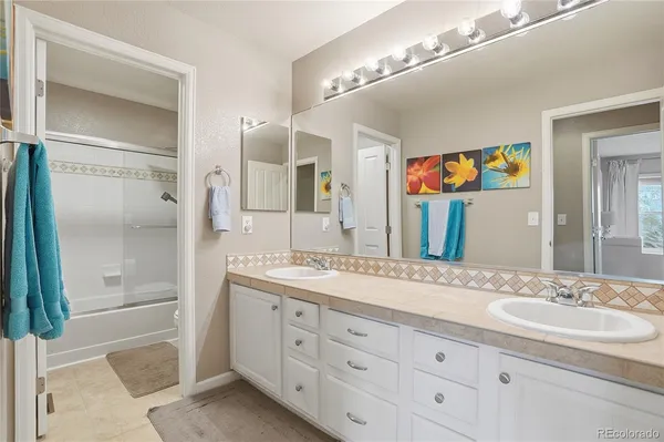a bedroom with a bed and a flat tv screen on dresser