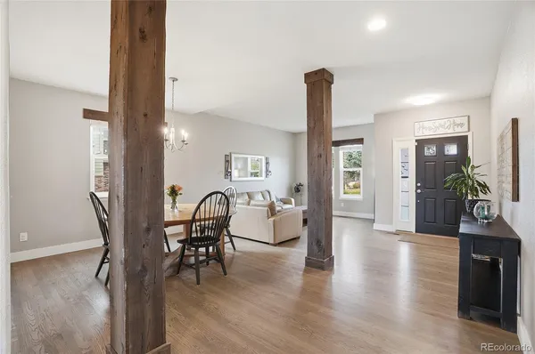 a dining room with furniture and wooden floor