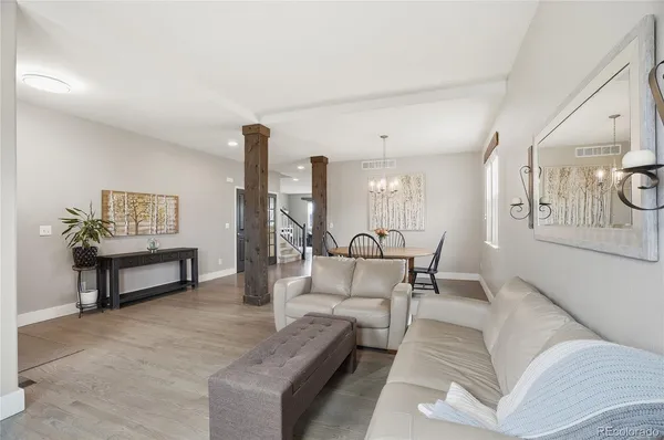 a living room with furniture and a lamp