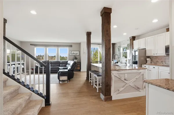 a view of a living room with furniture and floor to ceiling window