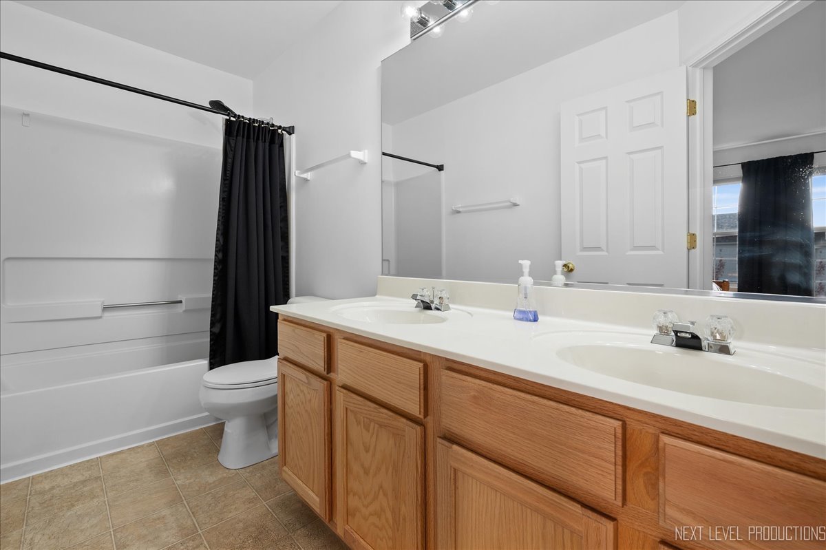 557 Springbrook Trail North Oswego, IL 60543 - Photo 12 of 25 a bathroom with a sink toilet and shower