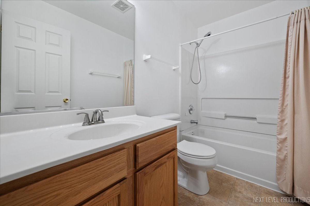 557 Springbrook Trail North Oswego, IL 60543 - Photo 13 of 25 a bathroom with a sink toilet vanity and shower