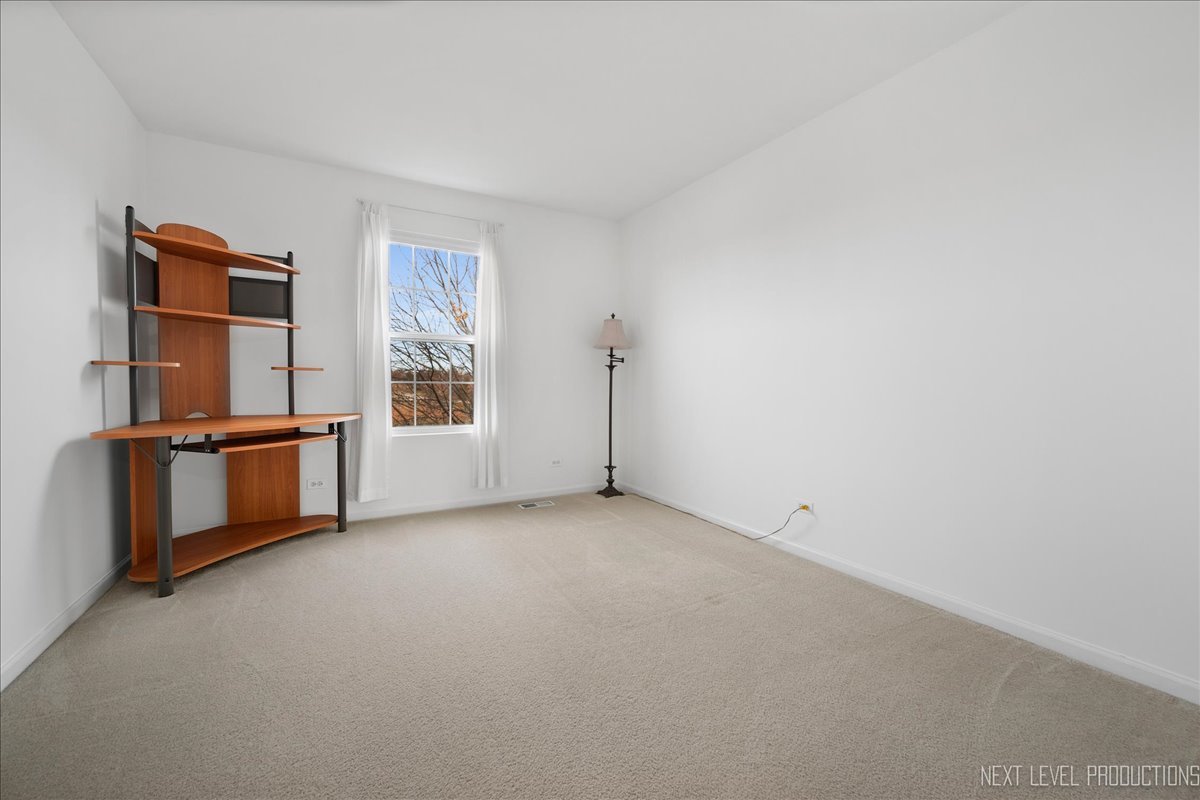 557 Springbrook Trail North Oswego, IL 60543 - Photo 15 of 25 a view of an empty room with a window