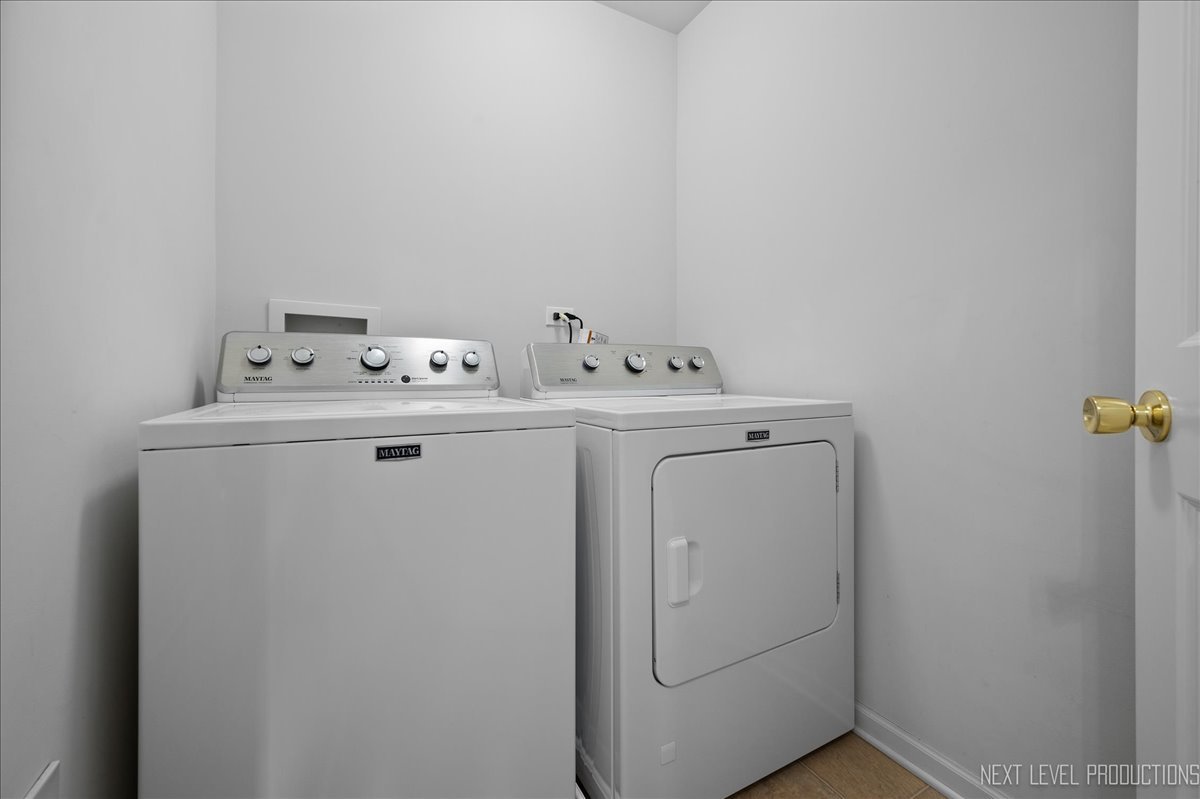 557 Springbrook Trail North Oswego, IL 60543 - Photo 16 of 25 a utility room with dryer and washer
