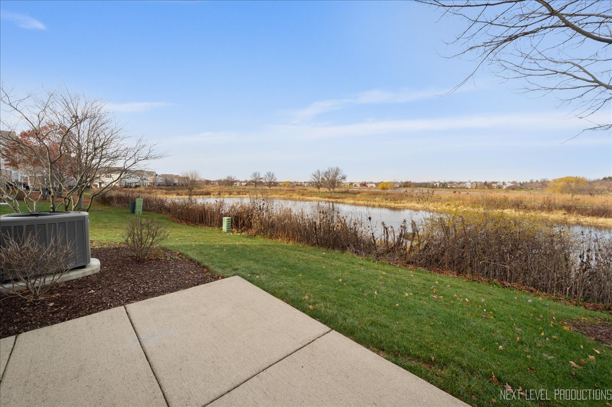 557 Springbrook Trail North Oswego, IL 60543 - Photo 17 of 25 a view of a lake with a big yard