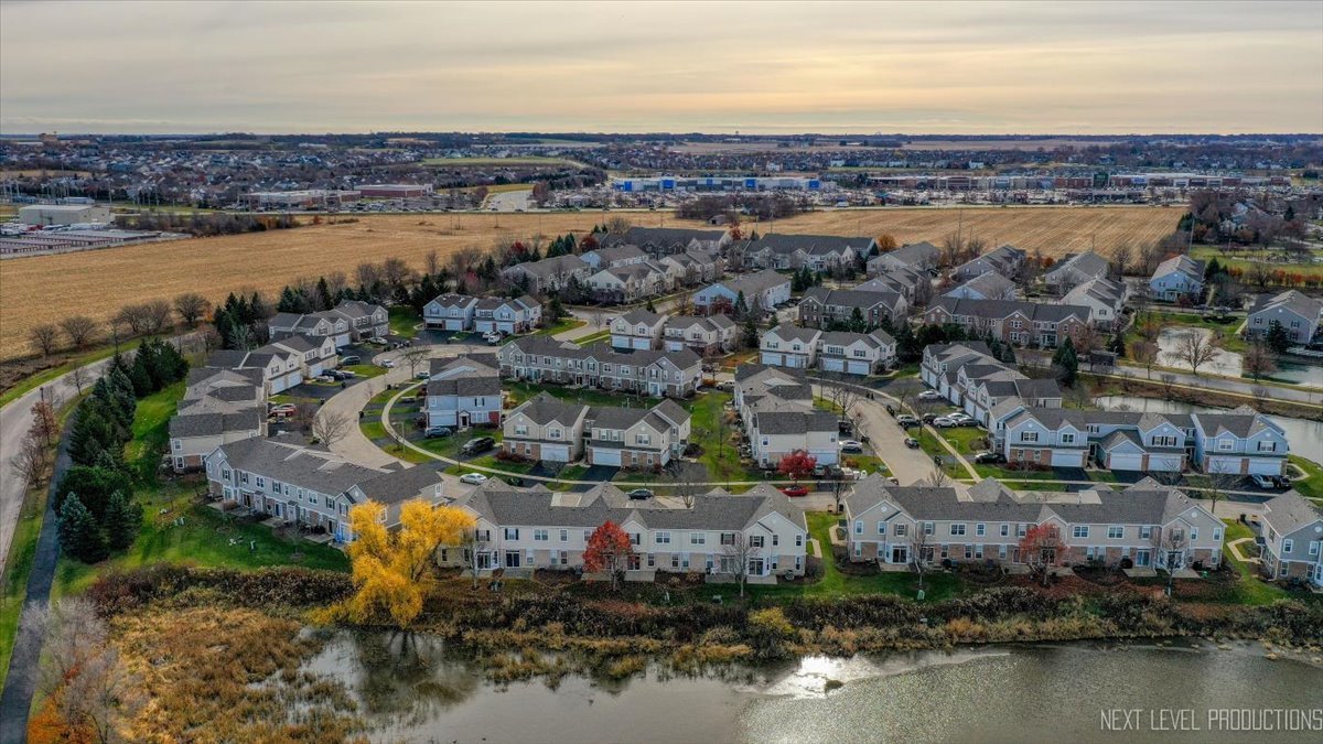 557 Springbrook Trail North Oswego, IL 60543 - Photo 20 of 25 an aerial view of residential houses with outdoor space and swimming pool