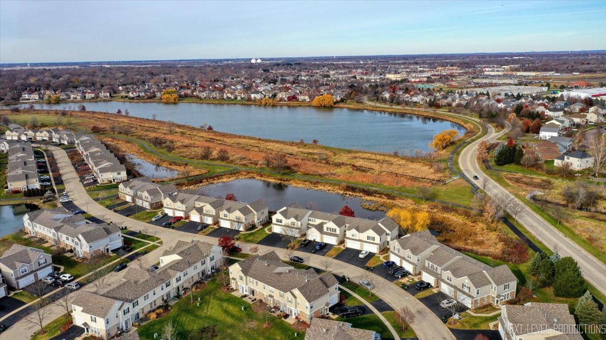 557 Springbrook Trail North Oswego, IL 60543 - Photo 2 of 25 an aerial view of residential building and lake