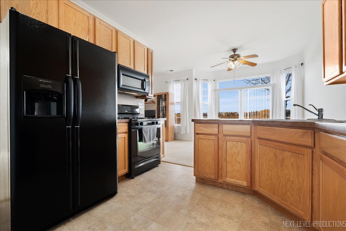 557 Springbrook Trail North Oswego, IL 60543 - Photo 9 of 25 a kitchen with cabinets and stainless steel appliances