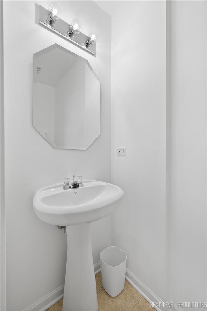 557 Springbrook Trail North Oswego, IL 60543 - Photo 10 of 25 a bathroom with a sink toilet and mirror