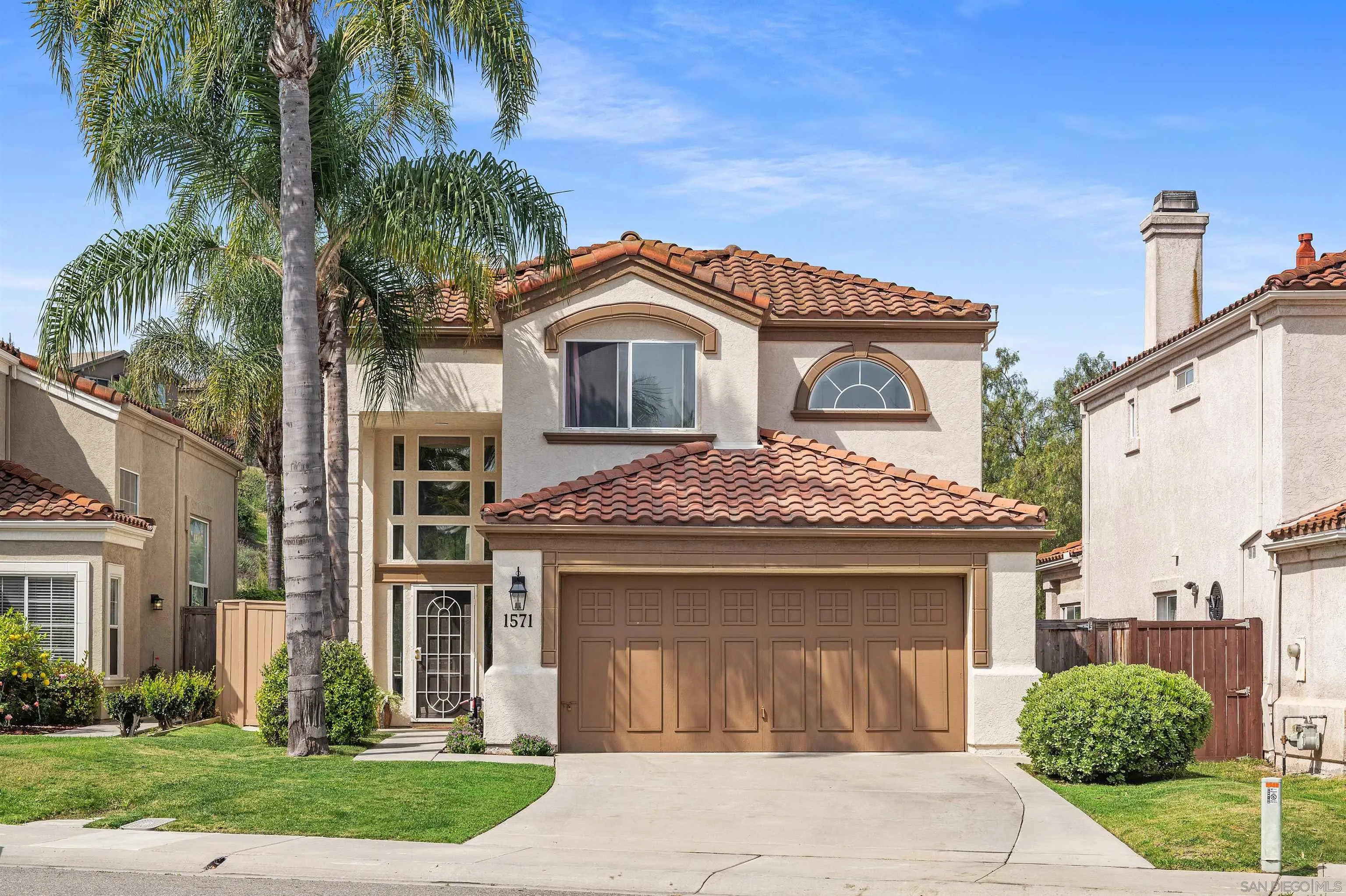 1571 Corte Daniel Oceanside, CA 92056 - Photo 1 of 44 a front view of a house with a garden and plants