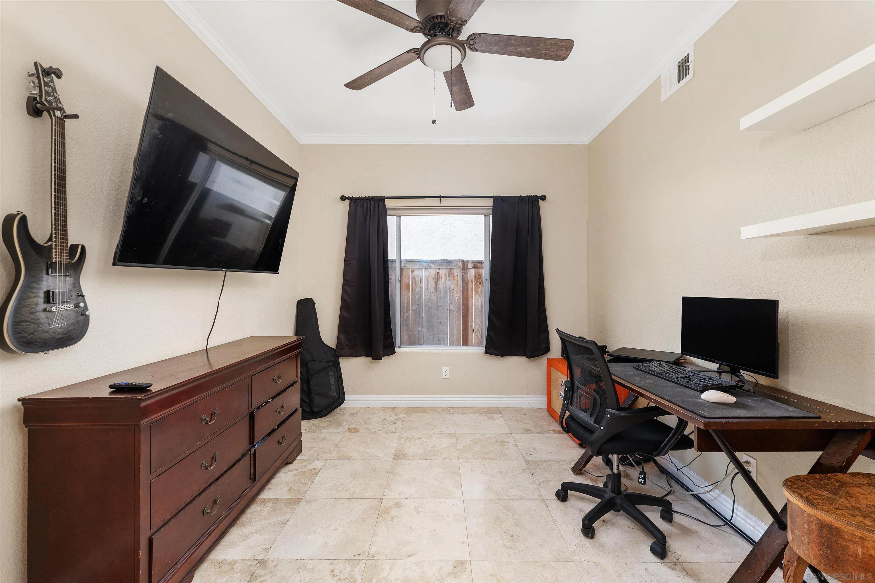 1571 Corte Daniel Oceanside, CA 92056 - Photo 11 of 44 a bedroom with a bed and a flat screen tv
