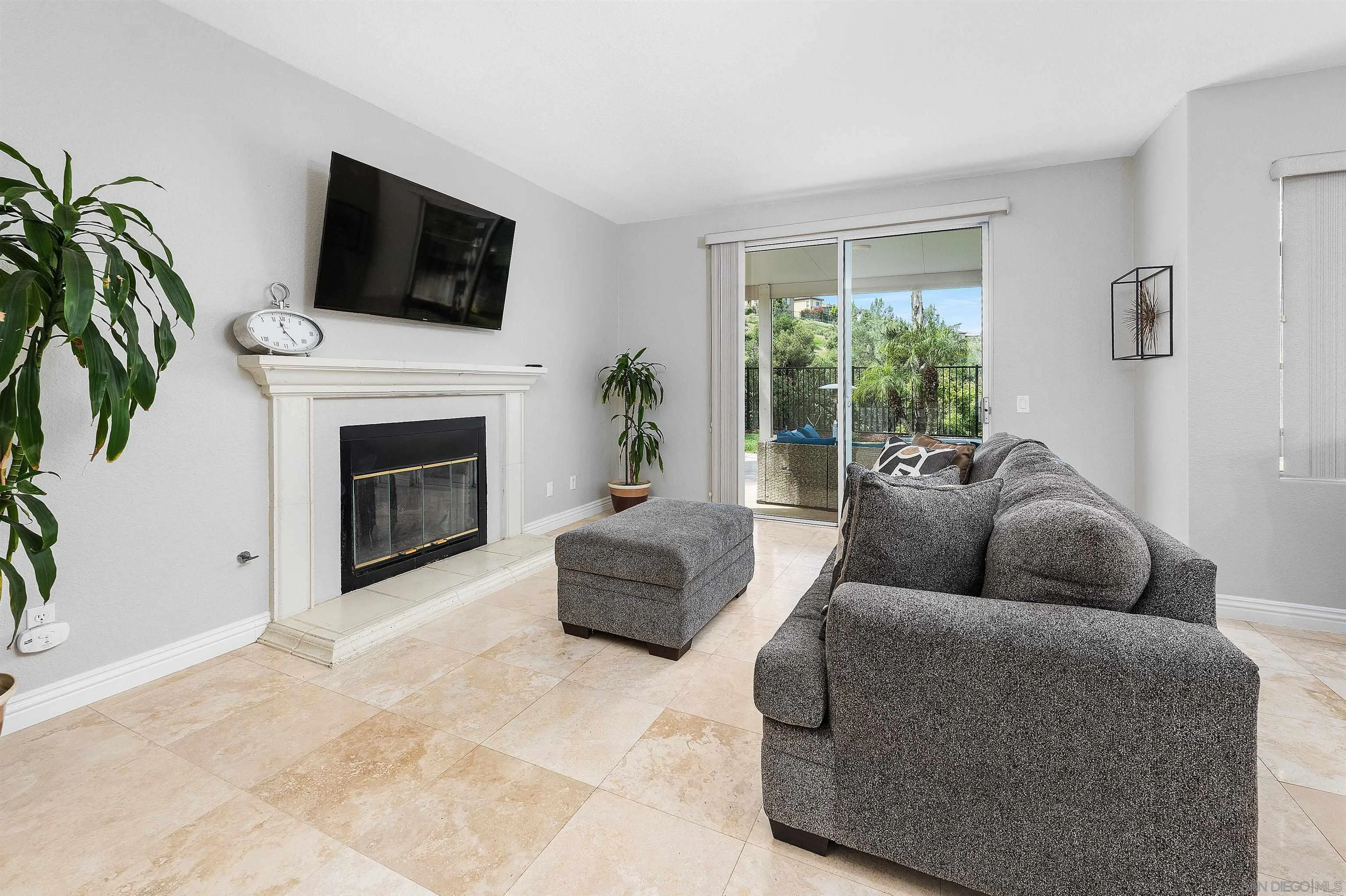 1571 Corte Daniel Oceanside, CA 92056 - Photo 17 of 44 a living room with furniture a flat screen tv and a fireplace
