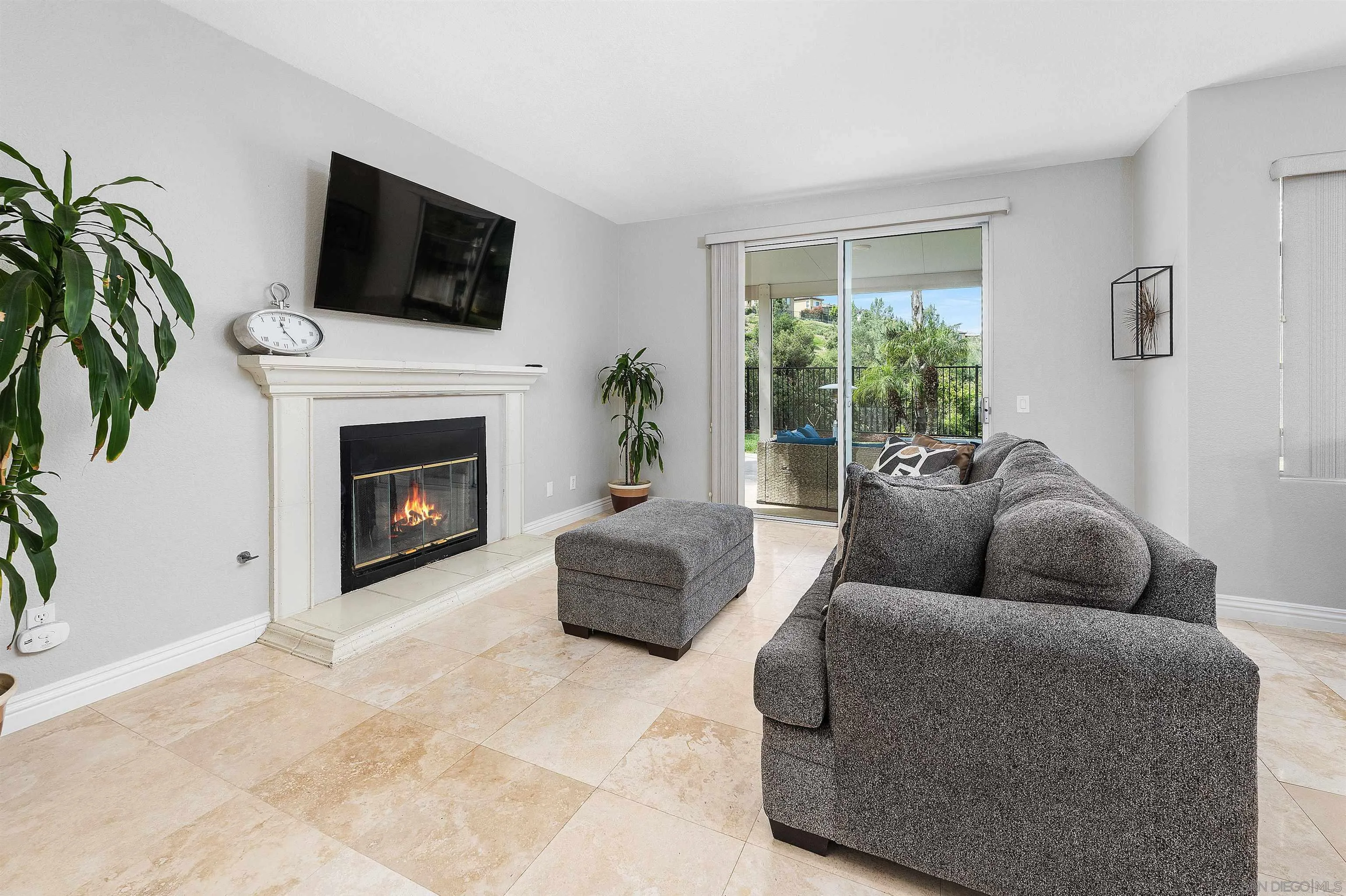 1571 Corte Daniel Oceanside, CA 92056 - Photo 18 of 44 a living room with furniture a flat screen tv and a fireplace
