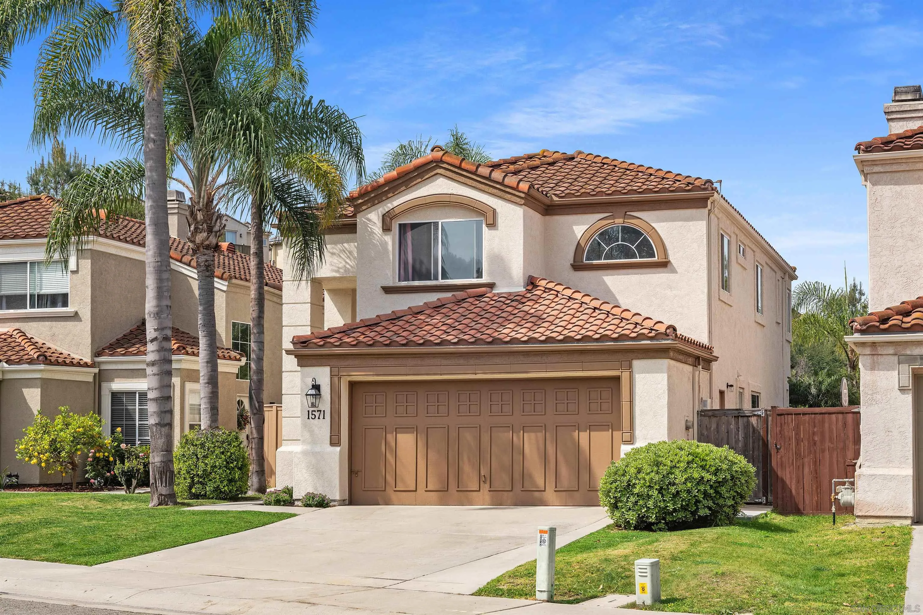 1571 Corte Daniel Oceanside, CA 92056 - Photo 2 of 44 a front view of a house with a garden