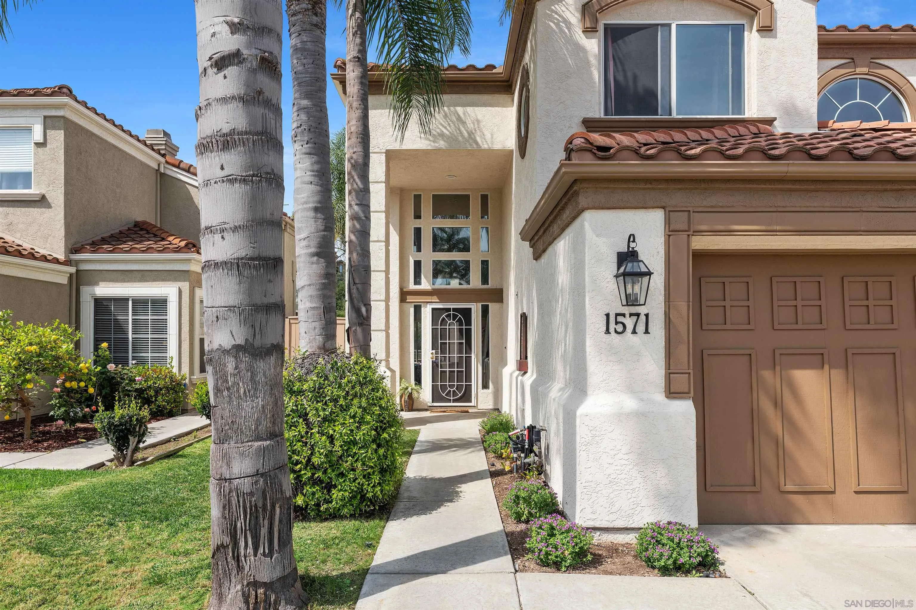 1571 Corte Daniel Oceanside, CA 92056 - Photo 3 of 44 a front view of a house with garden