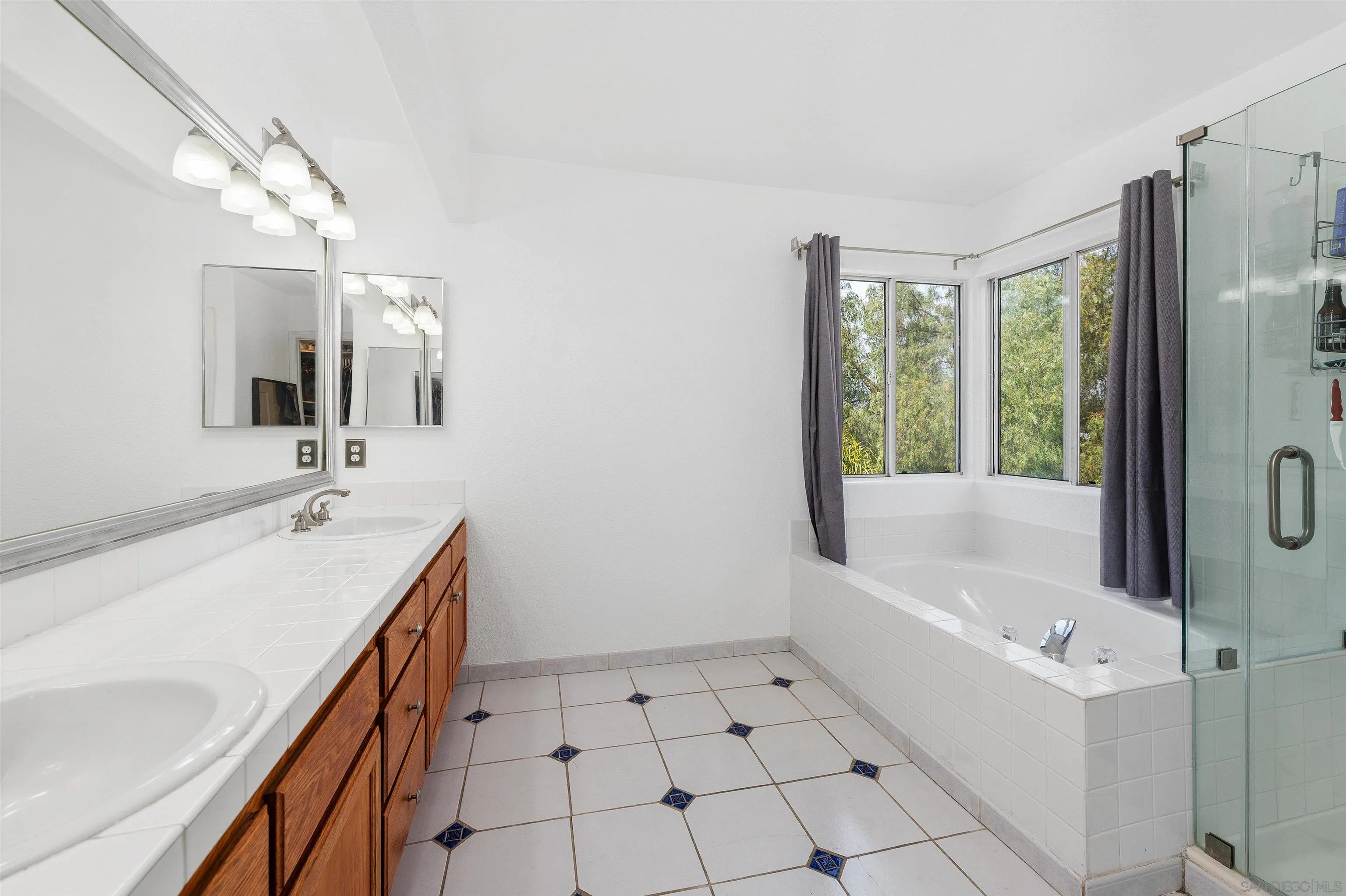 1571 Corte Daniel Oceanside, CA 92056 - Photo 36 of 44 a bathroom with a tub sink and mirror