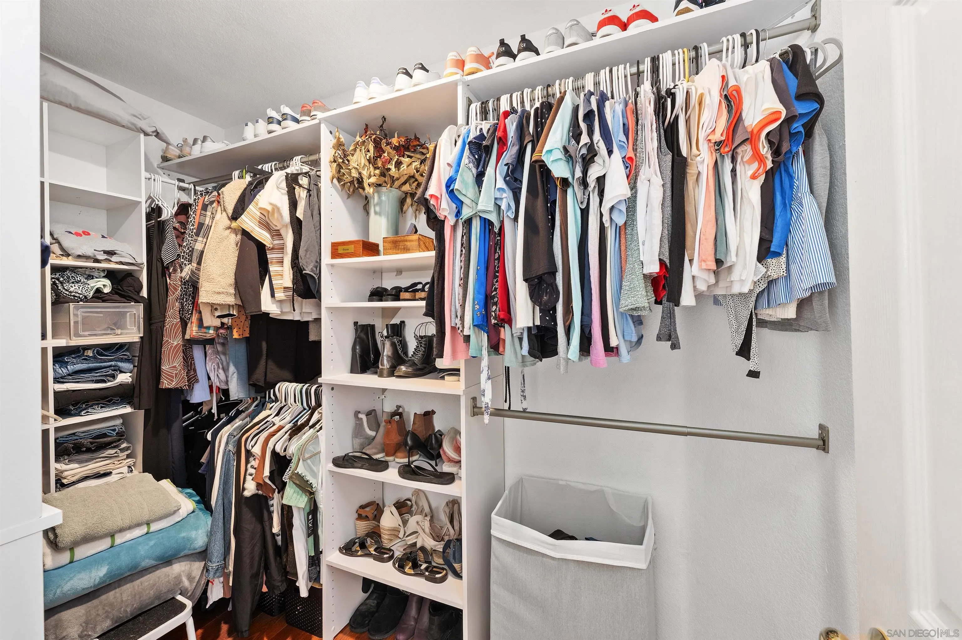 1571 Corte Daniel Oceanside, CA 92056 - Photo 38 of 44 a view of walk in closet with clothes and shoes