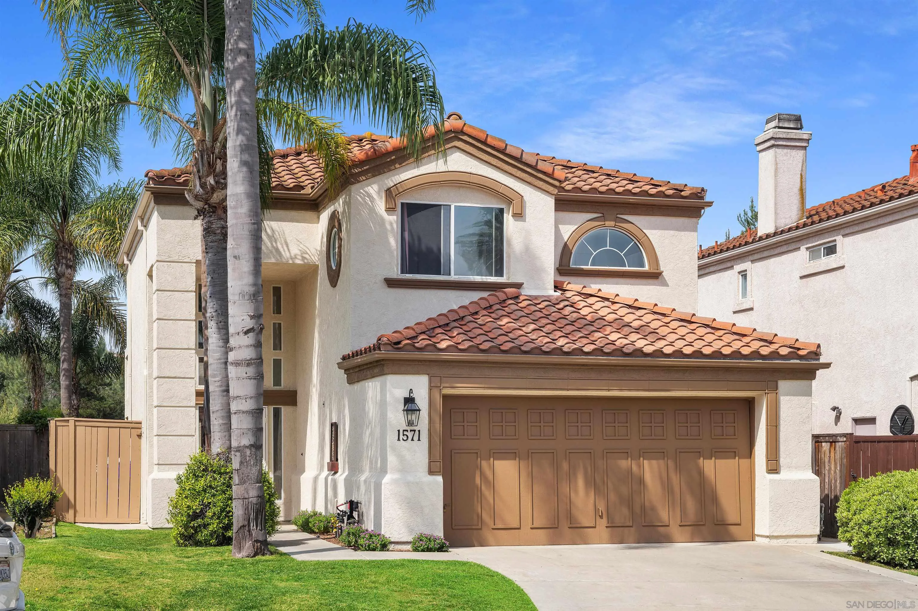 1571 Corte Daniel Oceanside, CA 92056 - Photo 4 of 44 a front view of a house with a yard and garage