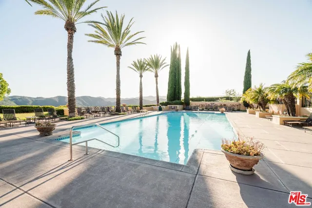 a view of swimming pool with outdoor seating and patio