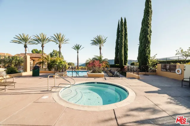 a view of a swimming pool with a lounge chair