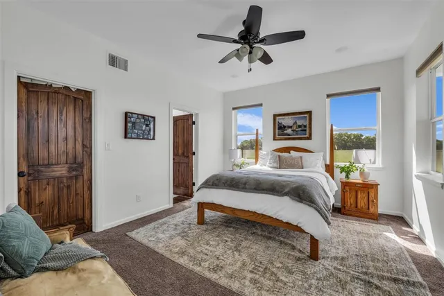 a bedroom with a bed a dresser and a window