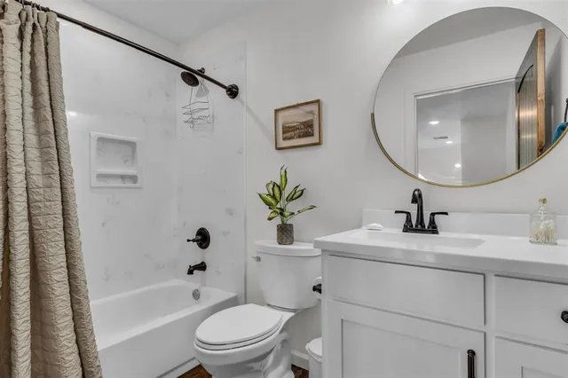 a bathroom with a sink a toilet and a mirror