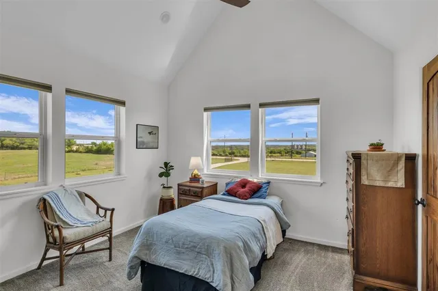 a bed sitting in a bedroom next to a window