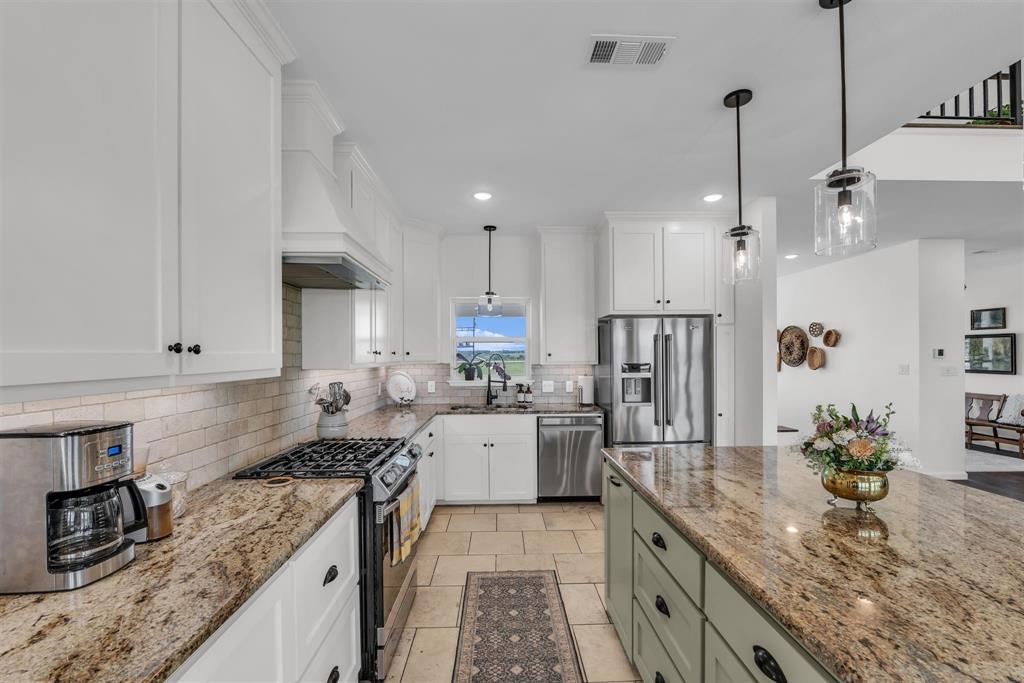 211 Knust Circle Gholson, TX 76705 - Photo 8 of 34 a kitchen with granite countertop kitchen island stainless steel appliances a sink stove and cabinets
