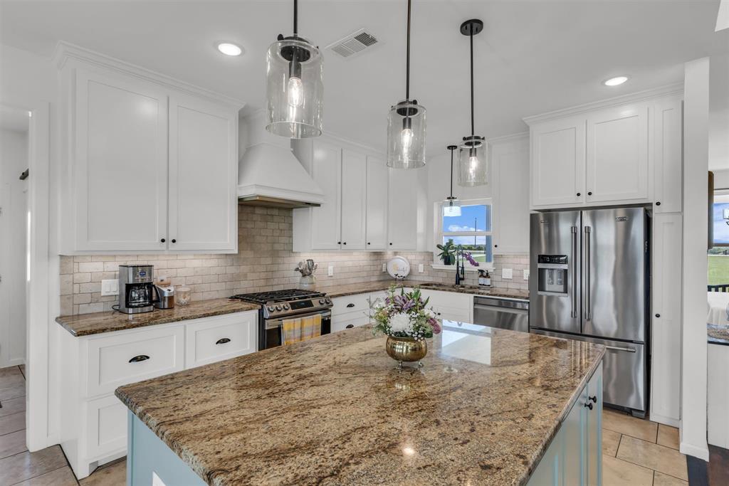 211 Knust Circle Gholson, TX 76705 - Photo 10 of 34 a kitchen with stainless steel appliances granite countertop a sink a stove and a refrigerator