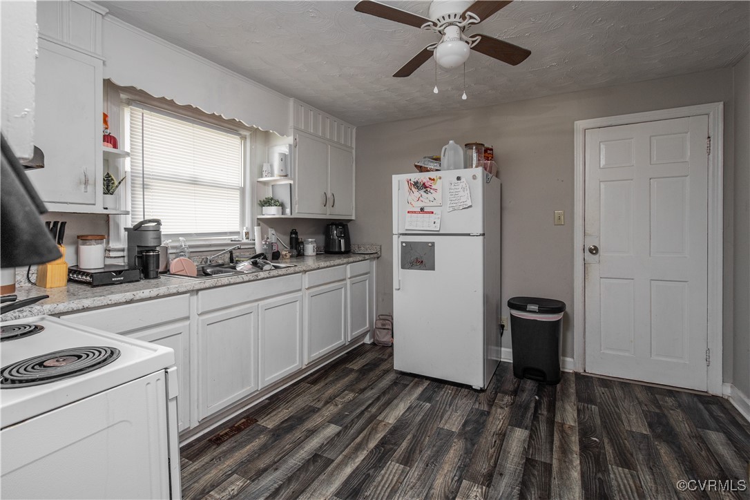 1707 Arlington Road Hopewell, VA 23860 - Photo 5 of 13 a kitchen with a refrigerator and white cabinets