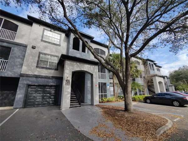 a front view of a house with parking space
