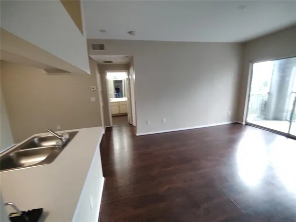 a view of a kitchen with a sink dishwasher and a microwave