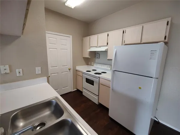 a kitchen with white cabinets and white appliances