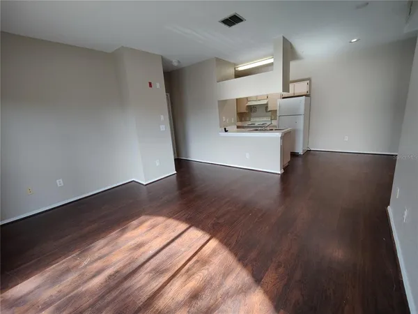 a view of a kitchen with a sink and a refrigerator