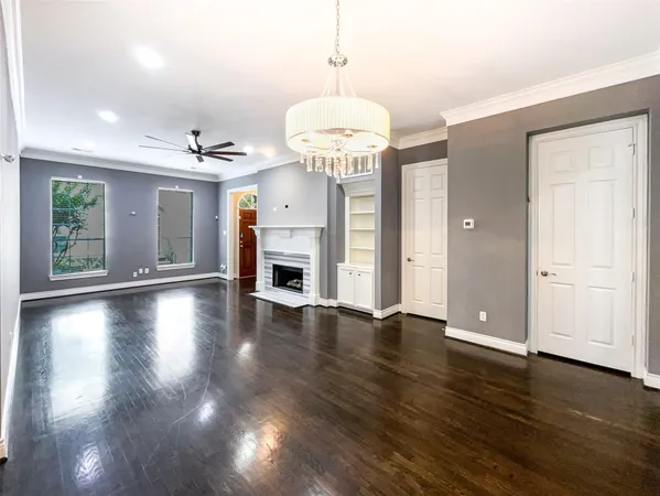a view of a livingroom with wooden floor and a ceiling fan