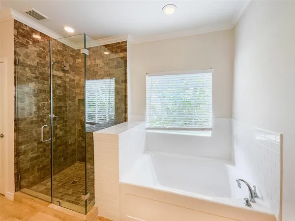 a bathroom with a bathtub and shower